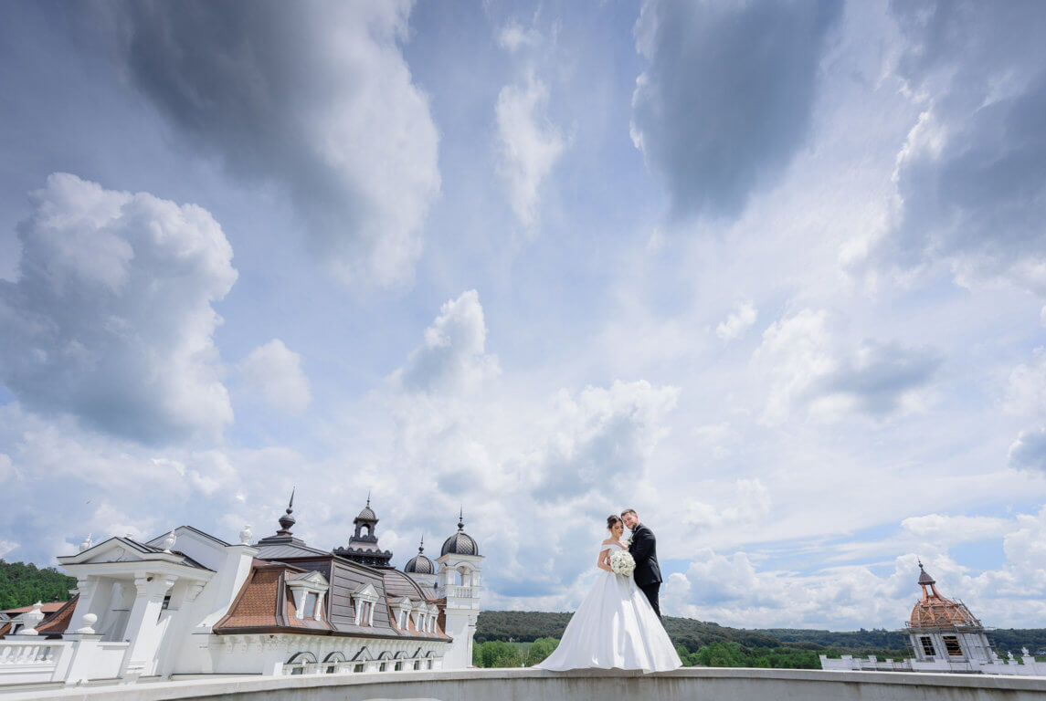 optimize-beautiful-wedding-couple-is-standing-near-church-with-beautiful-cloudy-sky.jpg